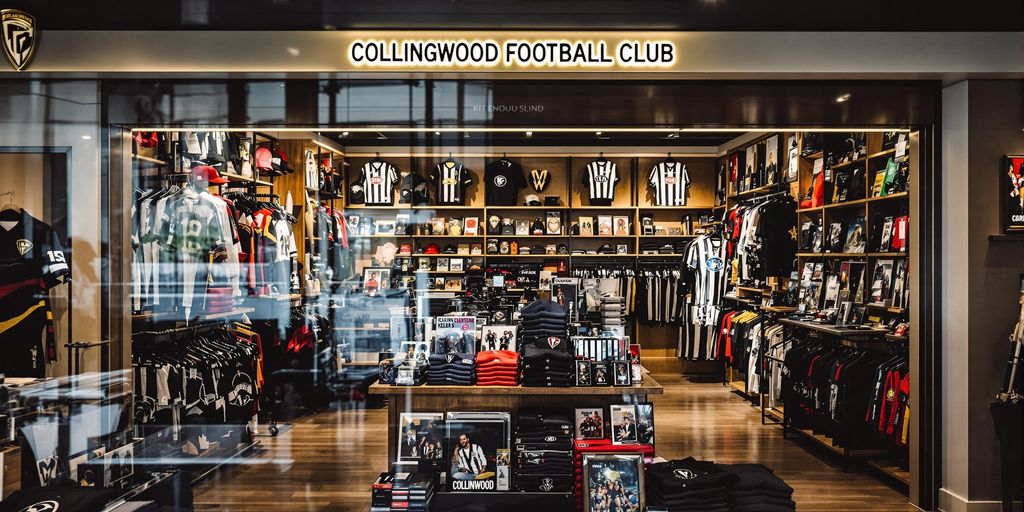 Photograph capturing vibrant Collingwood Football merchandise in busy shop display.