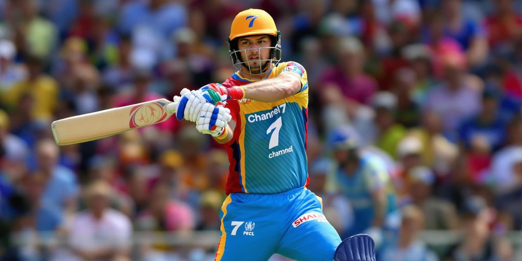 Cricket batsman in Channel 7 uniform, swinging bat in stadium.