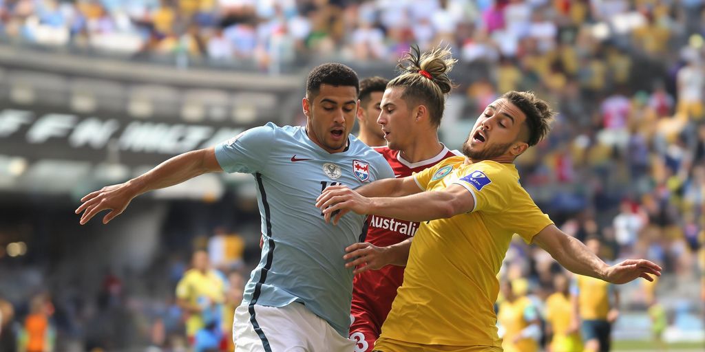 Football players clash on sunlit pitch in intense 2025 showdown.
