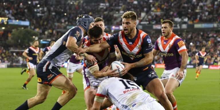 Broncos and Bulldogs players in intense rugby match action