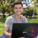 Australian student on campus using Netflix on laptop