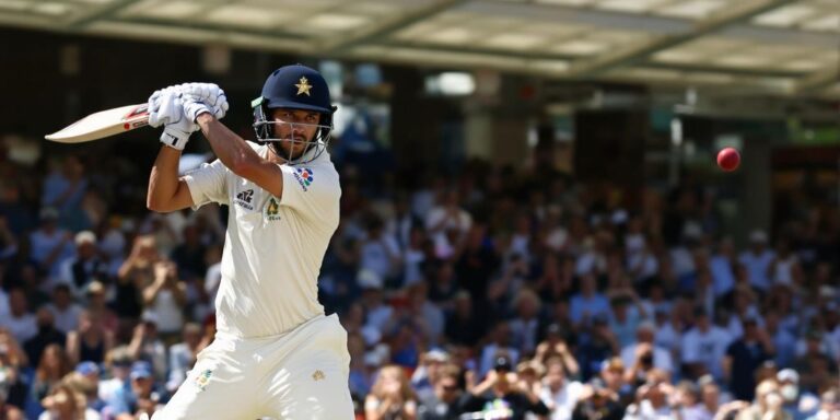 Australian cricketer batting on green field during Test match