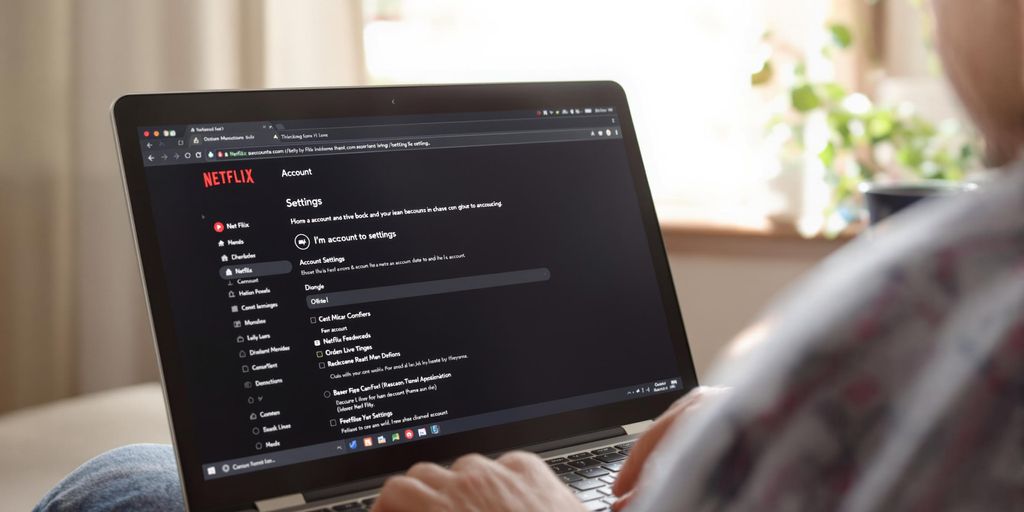 Person using laptop with Netflix homepage open