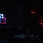 People watching scary movies in a dark living room