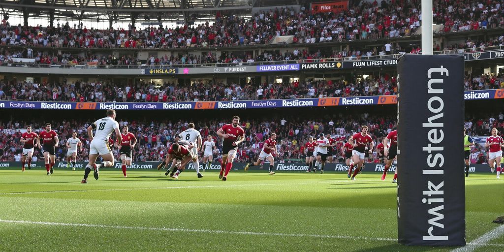 Rugby sevens players sprinting and diving during intense match