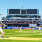 Australian cricket match action with players on a sunny field.