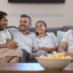 A family on a couch, enjoying Aussie streaming.