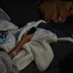 Bloke relaxed, remote in hand, ready for a telly binge.